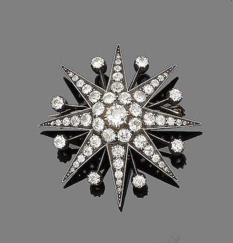 Bonhams : A diamond star brooch/pendant,