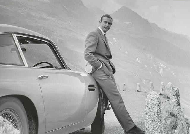 Bonhams : A photo-print of Sean Connery with the iconic Aston Martin DB5,