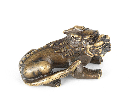 Bonhams : A parcel-gilt, bronze scroll weight Ming or Qing Dynasty