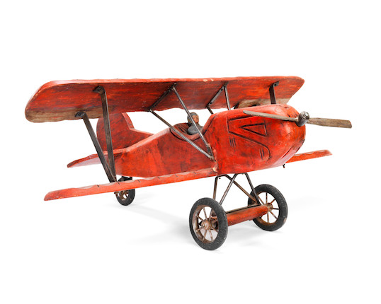 Bonhams : An early 20th century painted and carved wood model of a biplane