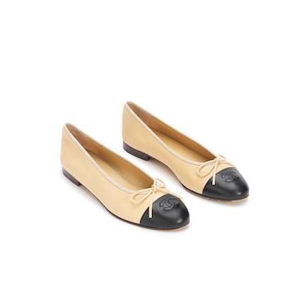Bonhams : A PAIR OF BEIGE AND BLACK BALLERINA FLATS Chanel, 2000 (includes dust  bag and box)