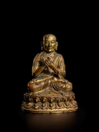 A GILT COPPER ALLOY FIGURE OF A LAMA TIBET, CIRCA 15TH CENTURY image 1