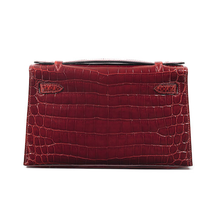 Bonhams : Hermès a Shiny Rouge H Niloticus Crocodile Kelly Pochette 2008  (includes felt protector and dust bag)