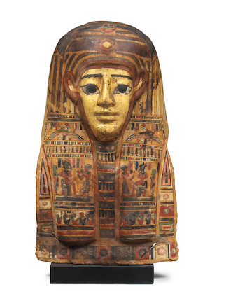 Bonhams : An Egyptian gilt polychrome painted cartonnage mummy mask