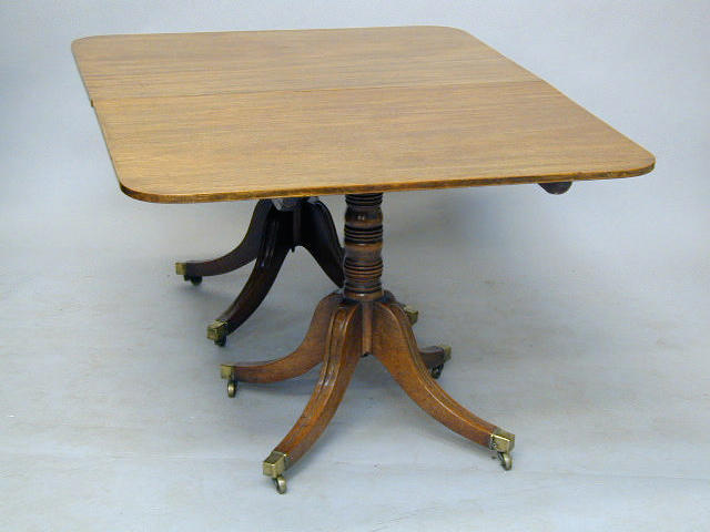 A Regency mahogany twin pedestal dining table,