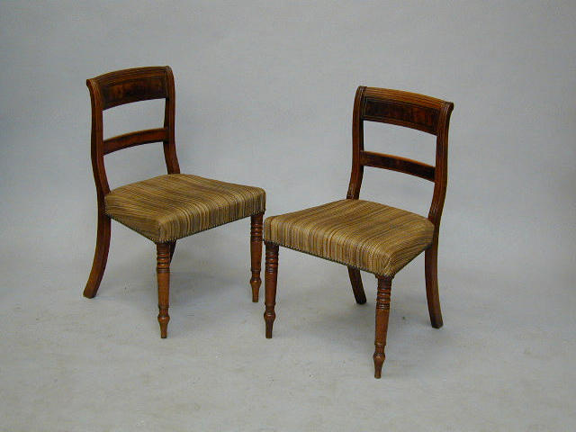 A set of six Regency mahogany and brass inlaid dining chairs,