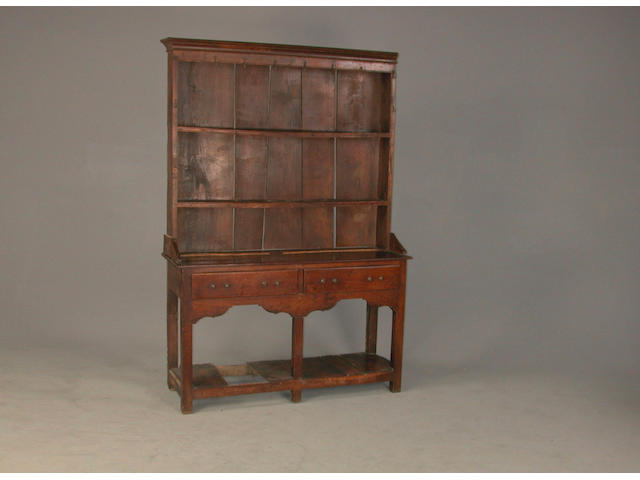 An early 18th century oak dresser 128 cms wide x 38 cms deep x 143 high