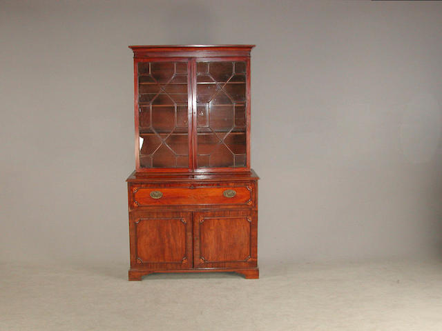 A Regency mahgoany secretaire bookcase, the astagal doors revealing adjustable shelves, with secretaire above to cupboard doors on b...