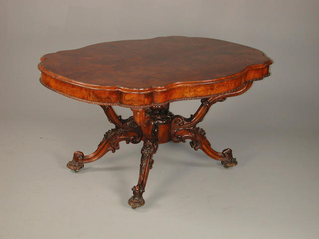 A mid Victorian carved walnut breakfast table 152 cm x 108 cm x 78 cm high