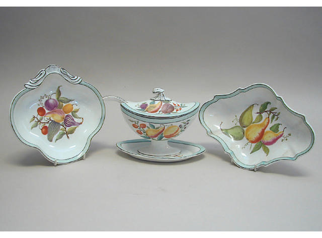 An early 19th Century dessert service, painted in colours with fruit and vegetables within pale blue washed bands and pierced borders, comprising a pair of pierced tureens and stands, a set of four kidney shaped dessert dishes, four shaped oval dessert dishes, oval comport, a pair of tureens, covers and ladles, with one stand and fourteen plates.