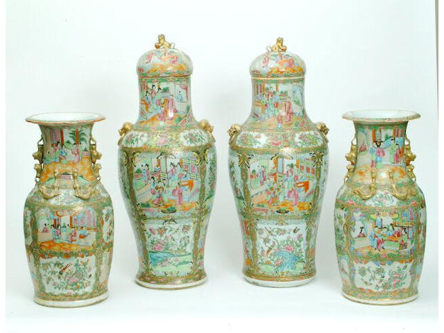 A pair of Canton Famille Rose floor vases and covers 67 cm high. (2)