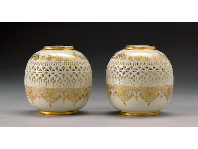 A pair of Royal Worcester reticulated vases by George Owen dated 1917