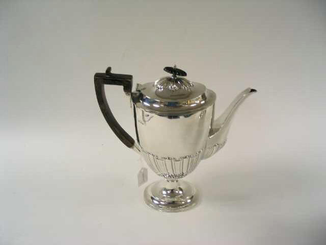 An Edwardian oval pedestal coffee pot, by Charles Stuart Harris, 1909,