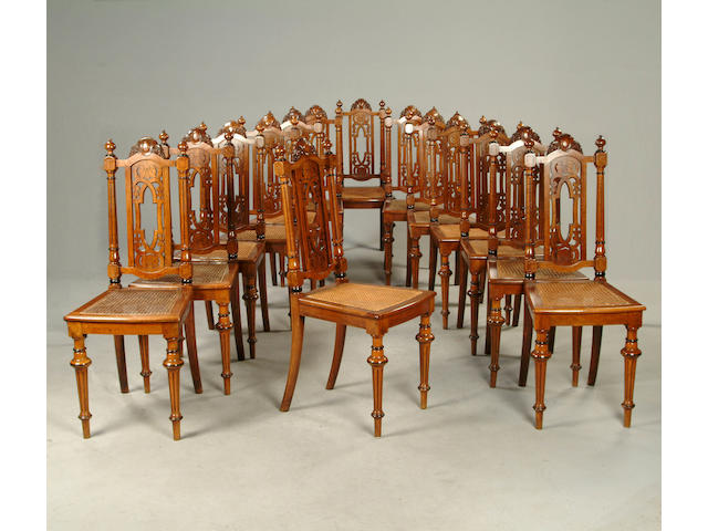 A set of fourteen Victorian walnut dining chairs