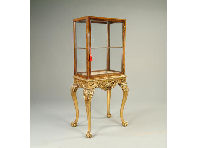 An early 20th century burr walnut and gilt wood display cabinet on stand