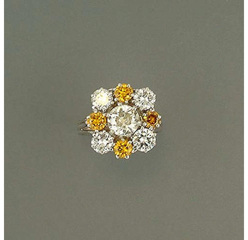 A diamond and fancy deep orangey/yellow diamond cluster ring