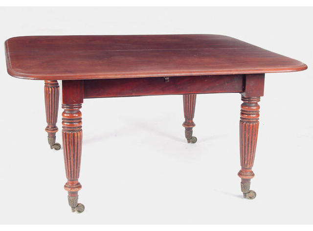 A William IV mahgoany dining table the top with rounded corners and a moulded edge, on tapered reeded legs with foliate brass cappings and castors, together with three leaves 360 x 143cm extended.