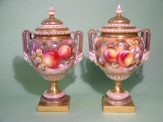 A good pair of Royal Worcester fruit painted vases and covers,