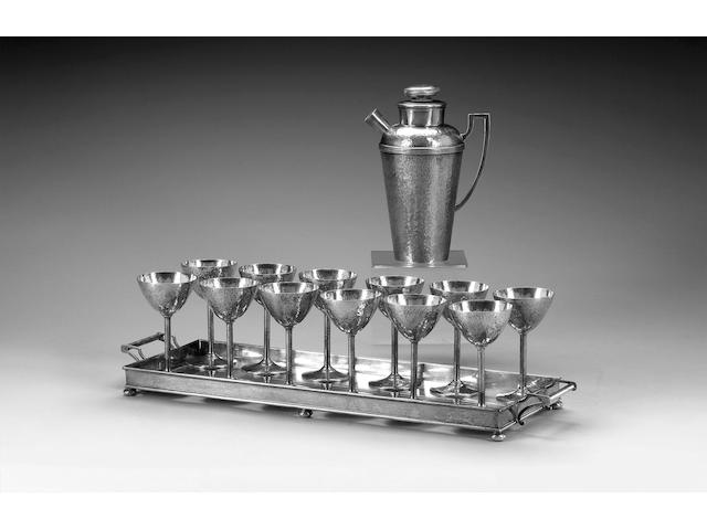 An American Art Deco Cartier cocktail service, the cocktail shaker with twelve goblets and a two-handled tray, marked Cartier, Sterling, impressed patented Dec. 28 1915,