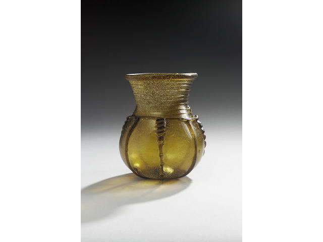 An Anglo-Saxon dark amber green glass globular beaker