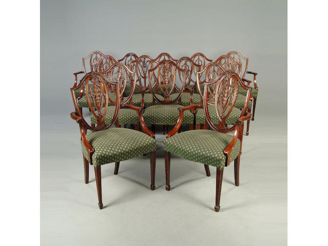 A set of thirteen mahogany shield back dining chairs