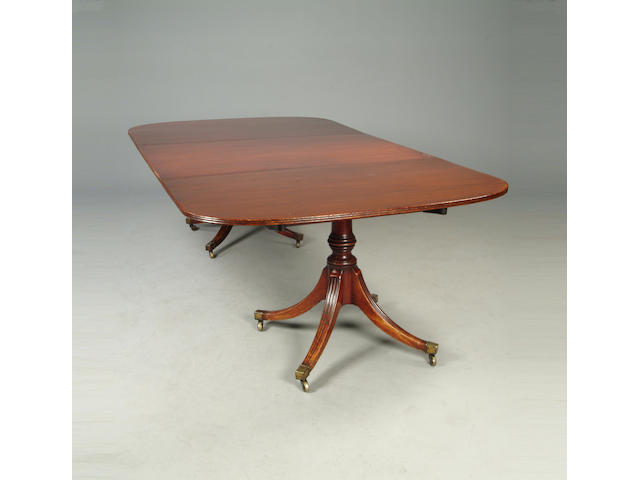 A Regency style mahogany twin pedestal dining table
