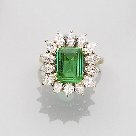 An emerald and diamond cluster ring