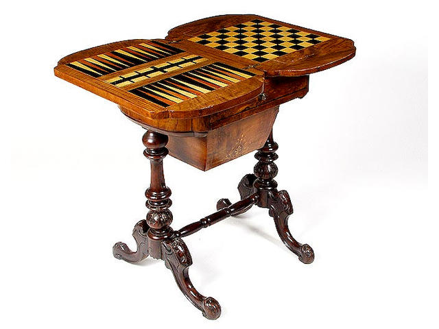 A mid Victorian walnut games/sewing table