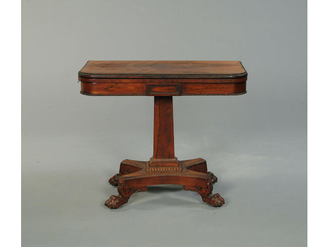 A Regency rosewood rectangular fold over swivel top card table