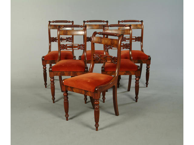 A set of six late Regency mahogany and brass strung dining chairs