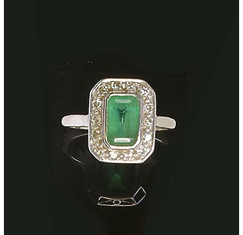 An emerald and diamond cluster ring