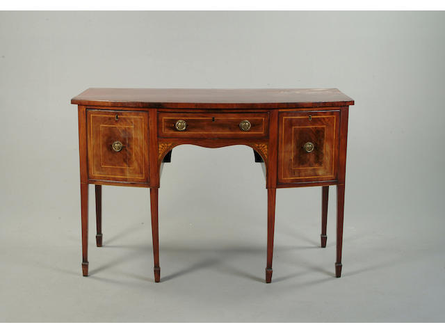 A George III mahogany and satinwood bow front sideboard