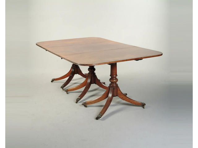 A George style mahogany triple pedestal dining table