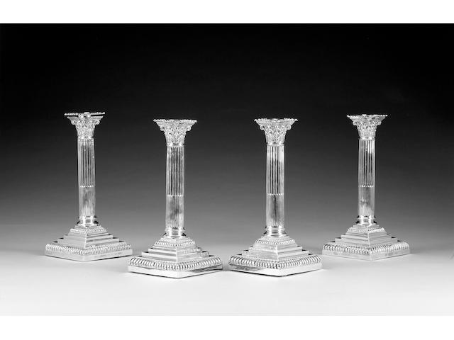 A set of four Edwardian silver Corinthian column candlesticks, by Hawksworth Eyre Ltd., Sheffield one 1903 three 1906,