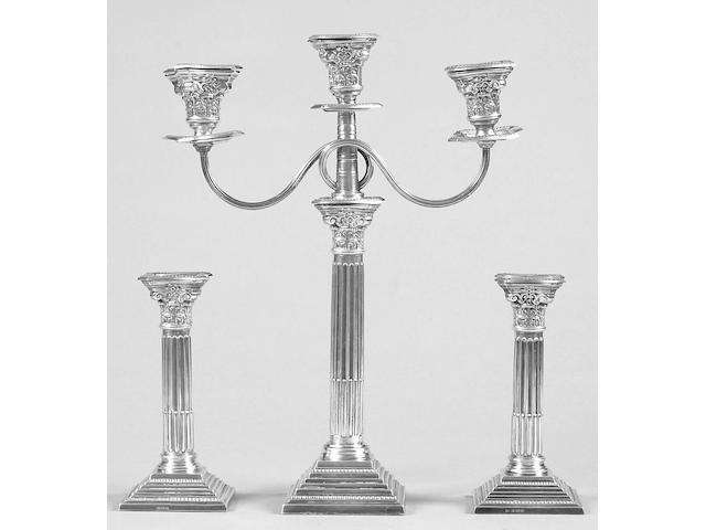 A matched candelstick and three light candelabra set the former makers mark worn, Birmingham 1959/60, the latter A.T & Son, 1961,