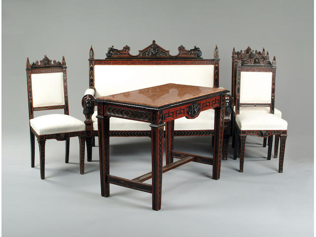An Egyptian revival carved and ebonised salon suite