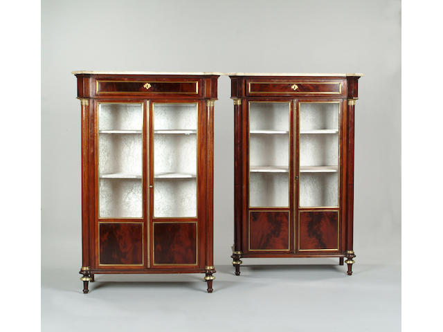 A pair of Directoire mahogany and brass mounted display cabinets