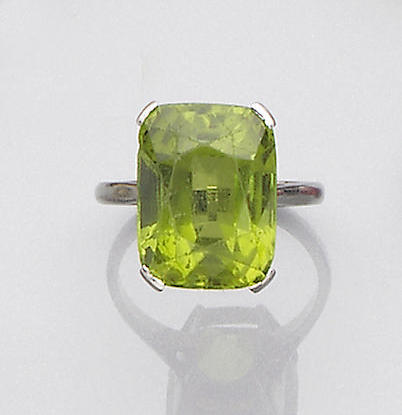An early 20th century peridot and diamond brooch and a peridot ring (2)