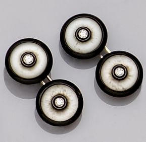 A diamond, onyx and frosted rock crystal dress set Comprising a pair of double cufflinks, and four buttons (two adapted as earstuds), each of circular form inset with central brilliant-cut diamond, contained in Cartier fitted case.
