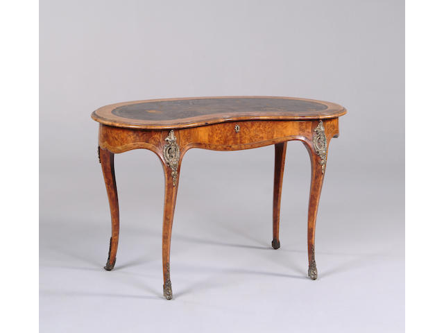 A Victorian walnut and gilt metal mounted kidney shaped table