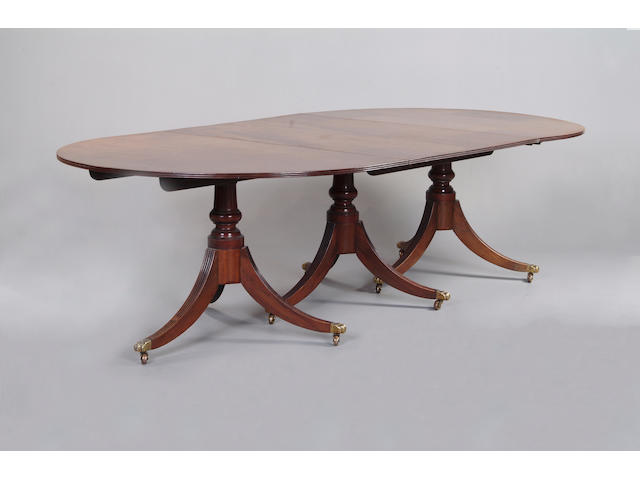 A good George III style mahogany triple pedestal dining table