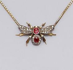 A late Victorian gold and silver mounted ruby and diamond bee brooch