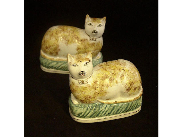 A pair of Staffordshire models of cats Late 19th Century