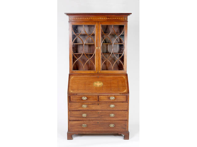 A George III mahogany bureau with a later bookcase top,