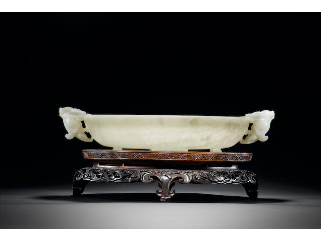 An important pale celadon jade shallow circular two-handled bowl Qianlong