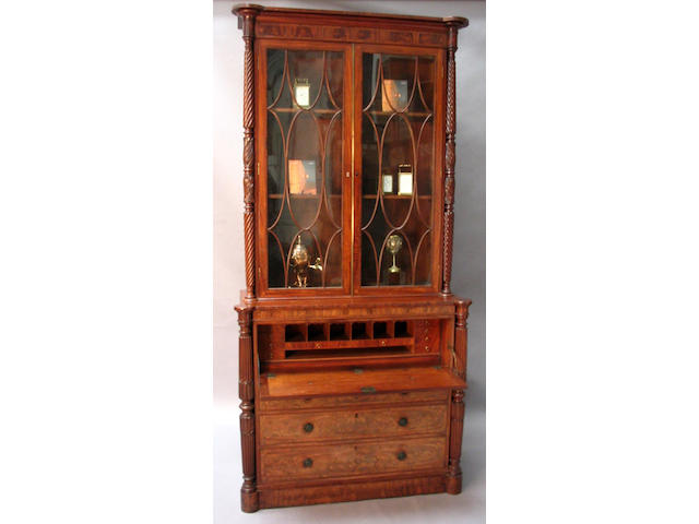 A George IV North Counties figured mahogany, rosewood crossbanded, floret and line inlaid secretaire bookcase