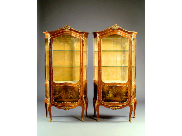 A pair of Louis XVI style ormolu mounted kingwood serpentine vitrines,