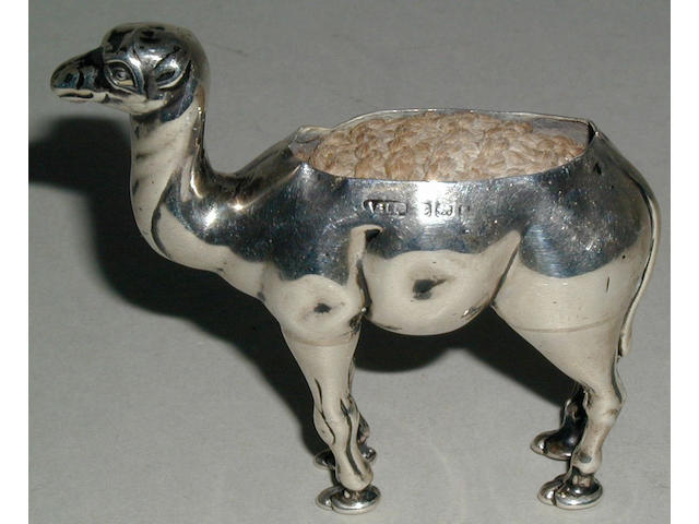 A silver pincushion in the form of a standing camel,