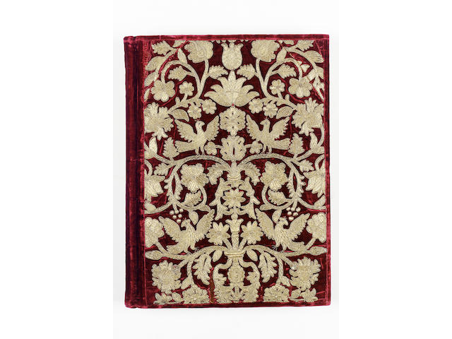 EMBROIDERED BINDING An album containing approximately 150 blank leaves, cover with a bold design of flower and foliage branching from a composite central stem, with birds perched on the branches, embroidered in gold thread on red velvet