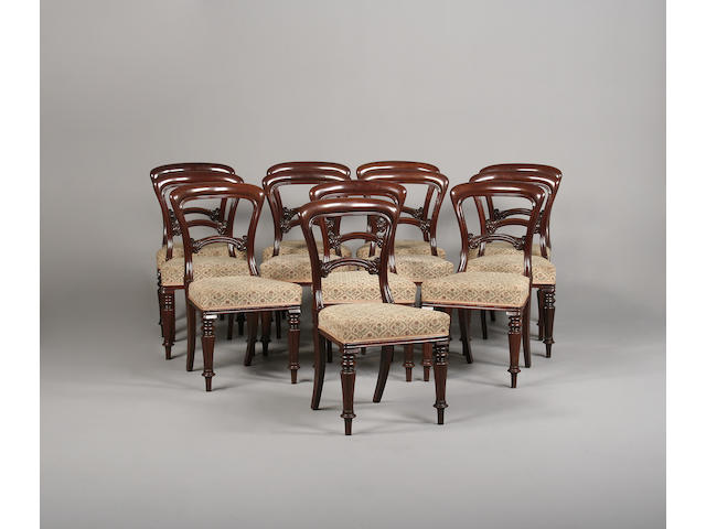 A set of twelve Victorian mahogany balloon back dining chairs labelled Edwards and Roberts